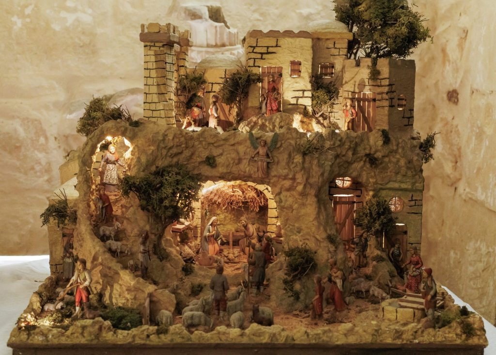 Maltese Christmas crib on display with a model village and nativity scene