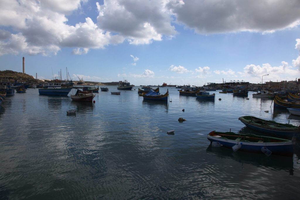 Fishing boats on calm water in Marsaxlokk harbour, Malta