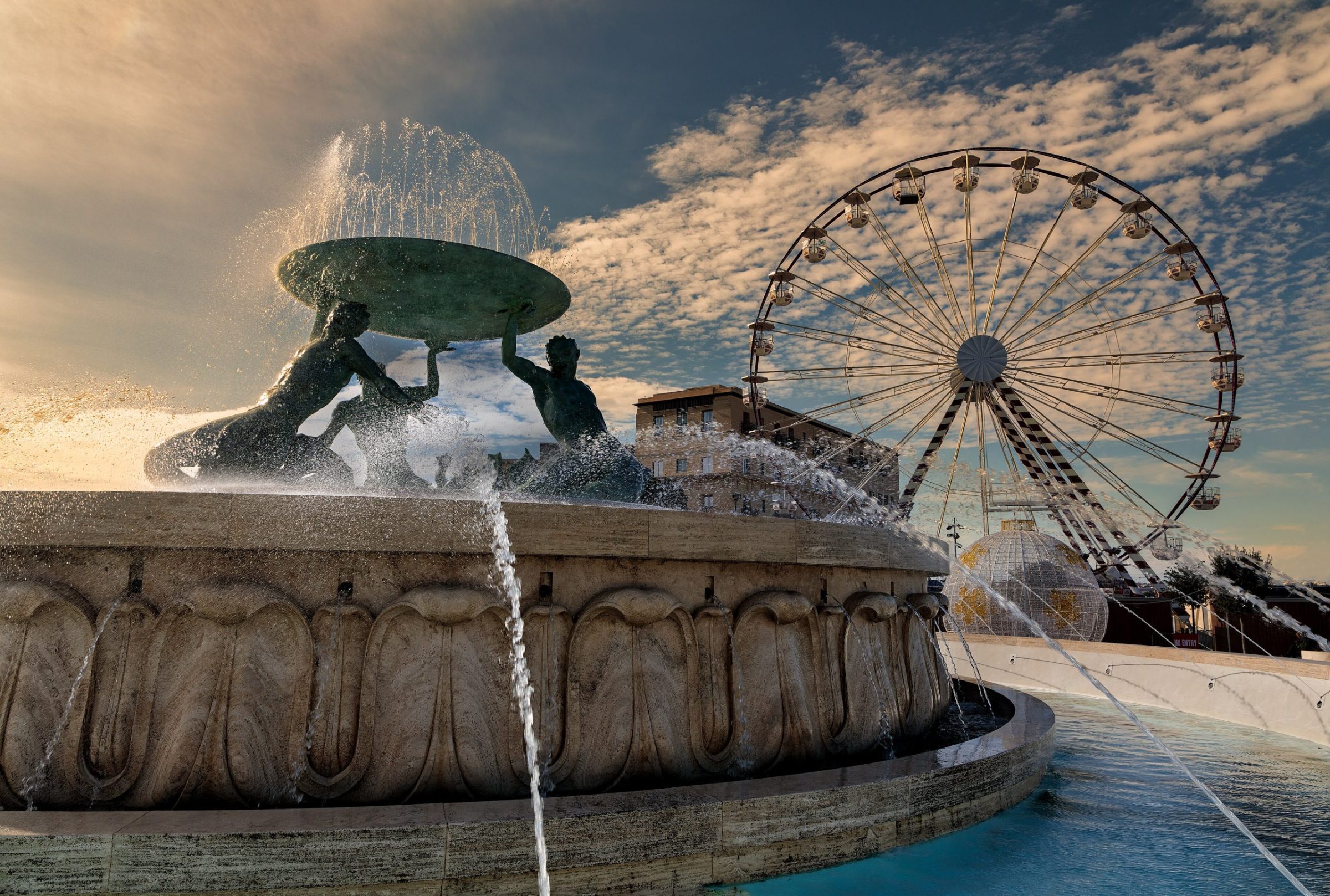 The Triton Fountain in Valletta with a Ferris wheel behind it, where Fairyland Santa City is held